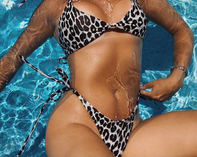 girl wearing a V neck shapred bikini top with tie around neck and back in leopard print